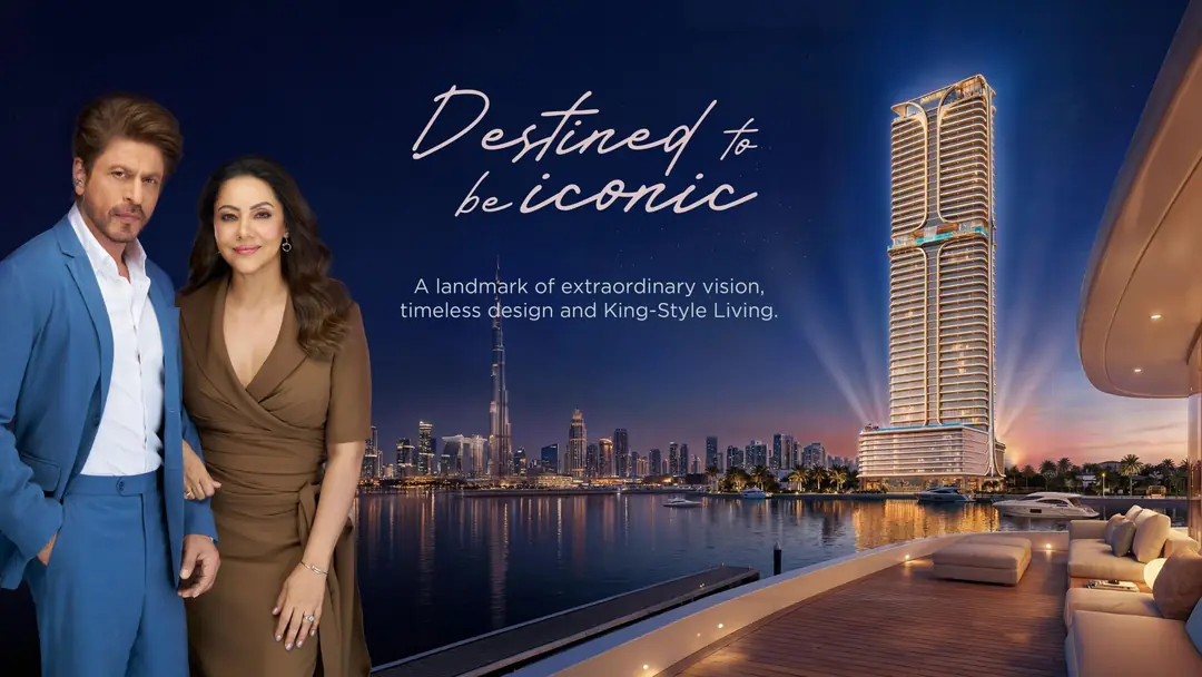 Shah Rukh Khan and Gauri Khan with the Shahrukhz Residences tower at night